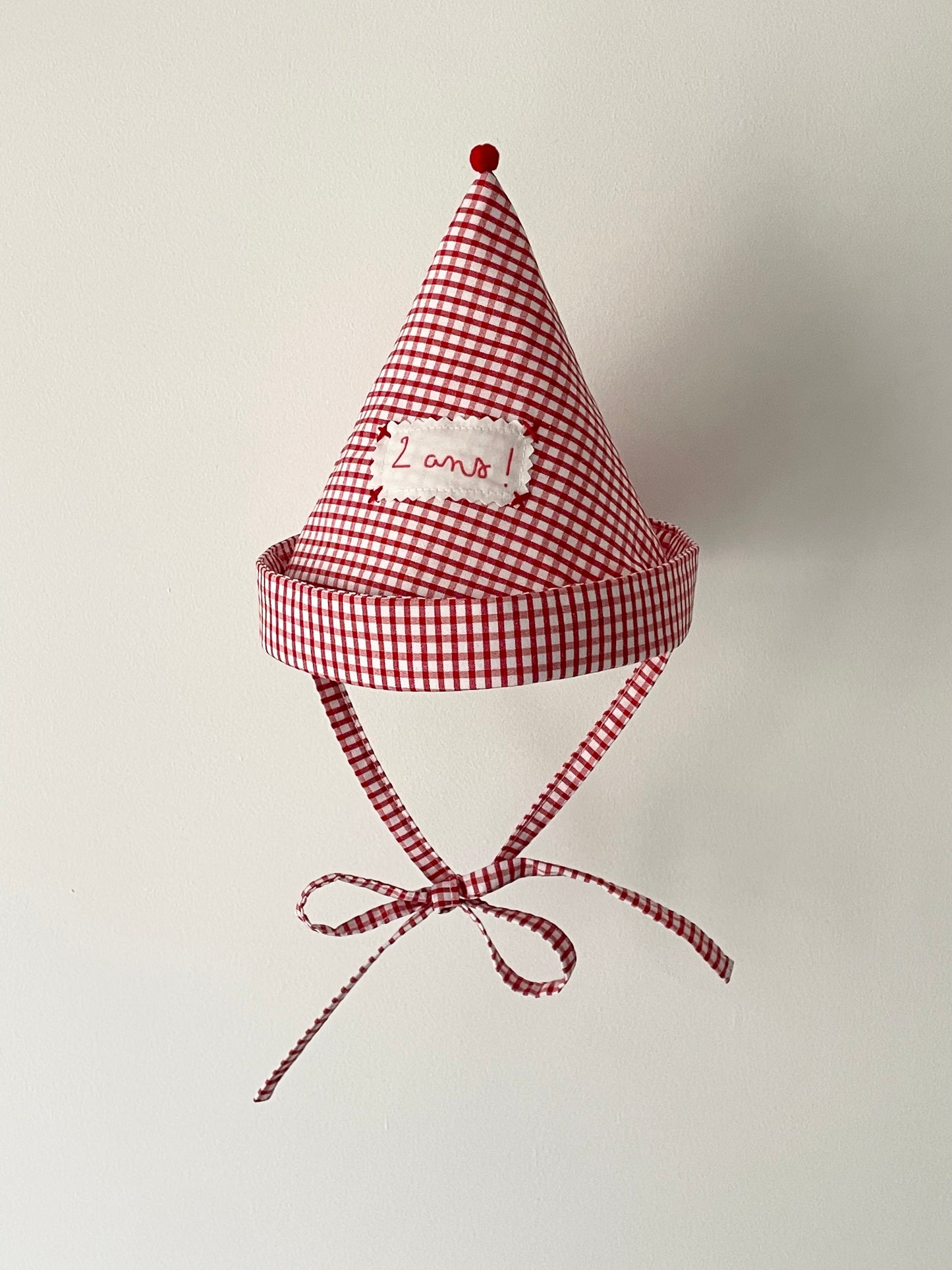 Pointed red checkered birthday hat